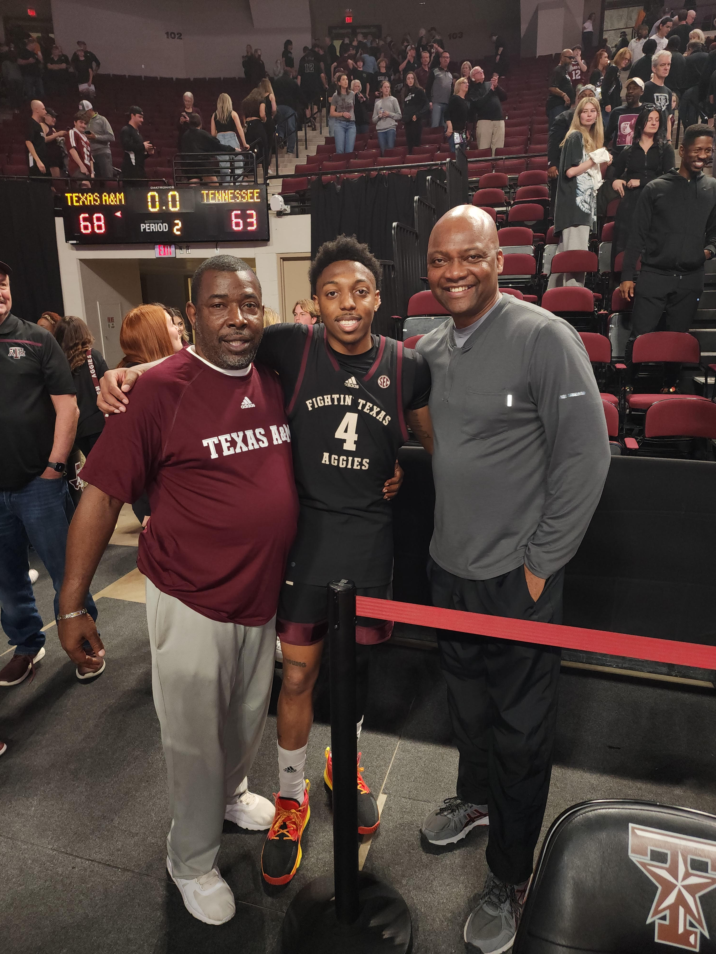 coach brown, lesley booker and Wade Taylor at the Aggies basketball game