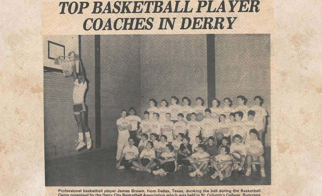 Coach Brown Performs a Dunk at his Basketball Clinic in Europe. Appeared in the newspaper article, “Top Basketball Player Coaches in Derry”